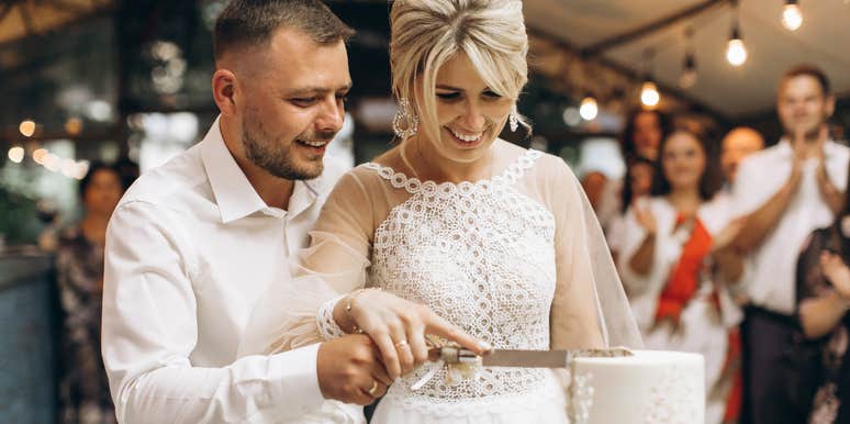 bride and groom cutting cake at wedding