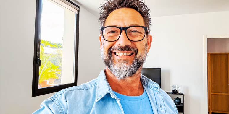 A stylish man in his fifties taking a selfie, capturing the excitement of a new life chapter and the realization that life gets easier with a clear perspective.