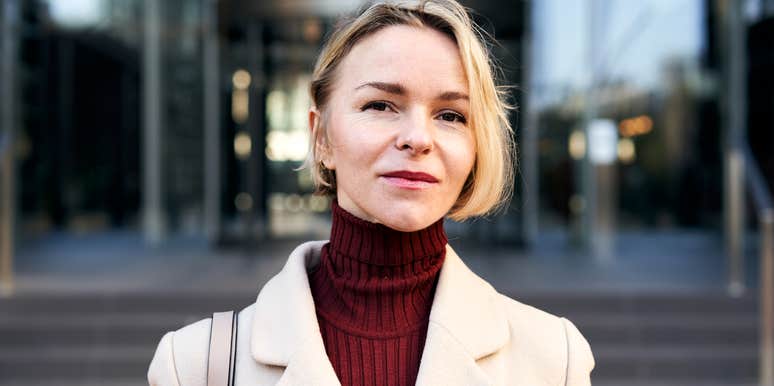 Middle-aged Caucasian businesswoman looking into camera serious. Beautiful 40-50 years old cheerful lady focused for the successes of work.