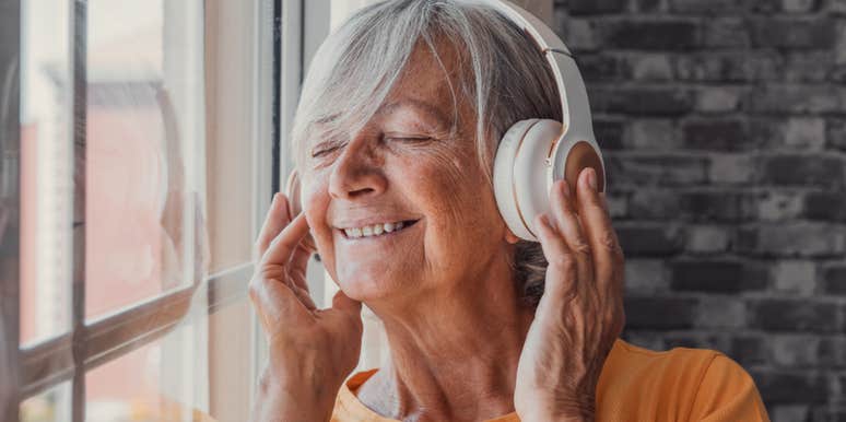 older woman listening to music with headphones