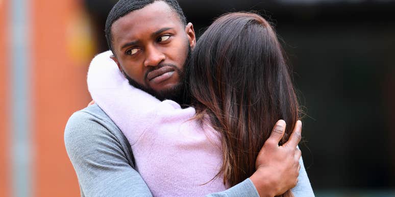 man who can't stand being hugged in a reluctant embrace