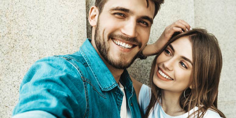 Woman who wants a man to like her smiles admiringly at him 