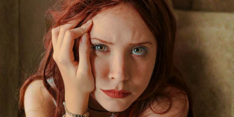 Woman with her hand on her face, appearing low and withdrawn, illustrating quiet slumps and strategies to climb back out