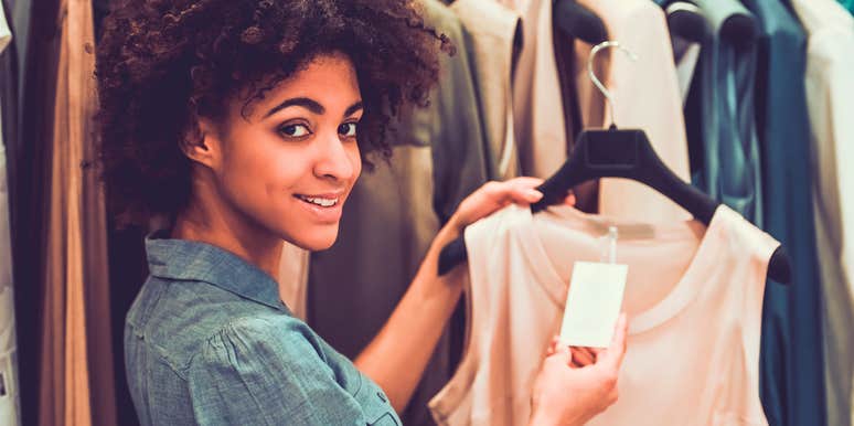 highly intelligent woman shopping in the sales rack at clothing store