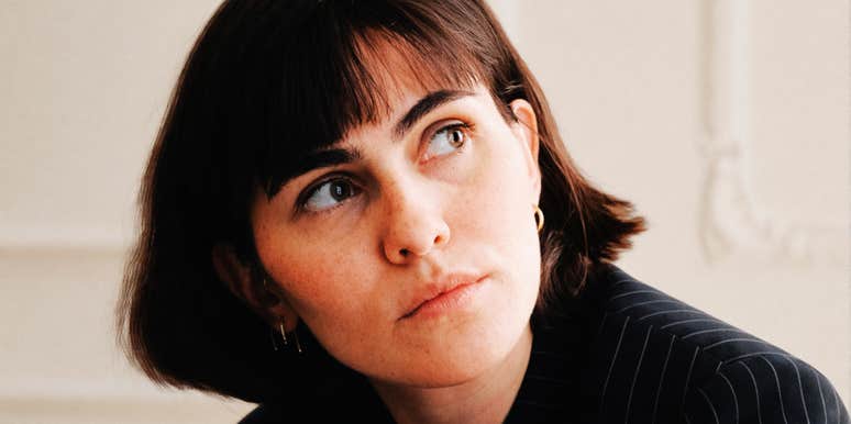 A thoughtful woman in a modern interior setting looking off-camera, representing the moment of reflection when 'kindness' is finally distinguished from 'being used' in personal relationships.