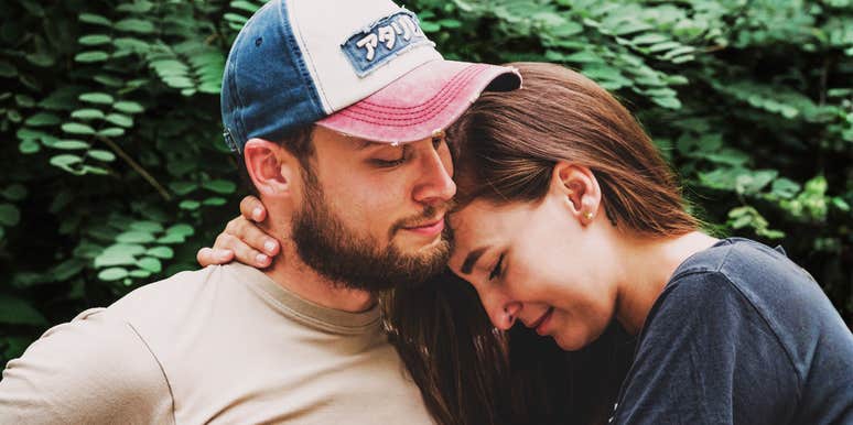 A woman resting her head on her husband in a moment of calm; illustrating the 'charming signs' of a partner whose personality mirrors a German Shepherd’s protective and devoted nature.