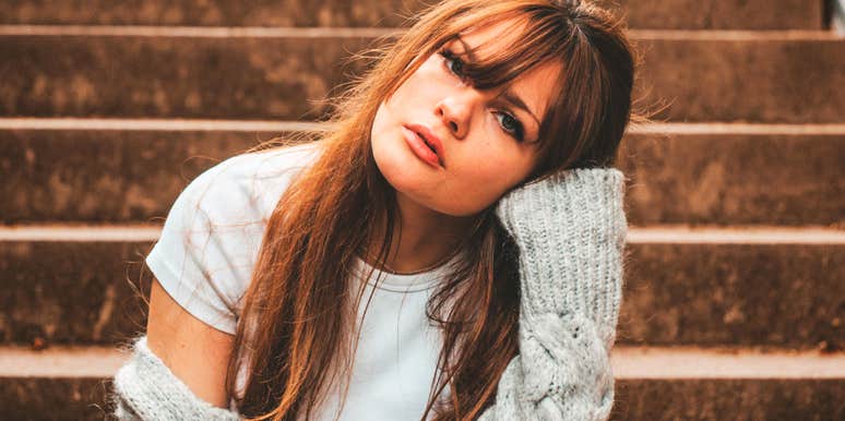 A woman feeling down and looking pensive; a visual representation of the internal emotional struggle and small, simple actions used to navigate unexplained depressive moods.