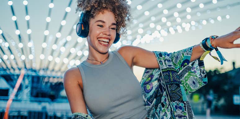 happy woman dancing with headphones on