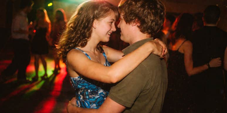 A nostalgic AI image of a high school girl slow-dancing with an ecstatic smile; illustrating the romantic energy of the era's classic love songs.