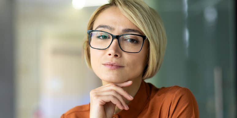 type a woman with glasses resting head on hand