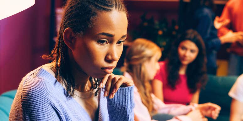 young woman feeling like she doesn't belong in group of friends