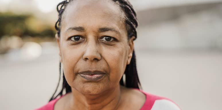 A parent whose adult children resent her looks sternly at the camera 