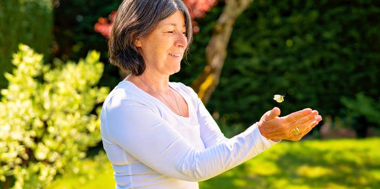 woman with rare emotional gifts releasing a bug outside after saving it