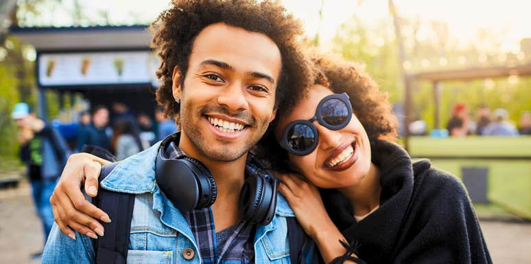 happy youngest sibling being hugged by his mom