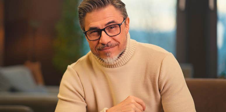 middle aged man with attractive traits smiling confidently