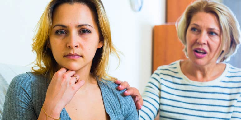 adult woman sitting next to her mother talking to her