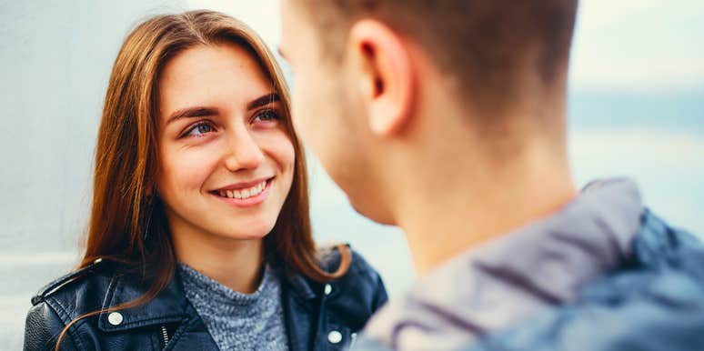 happy woman saying i love you without words to her partner