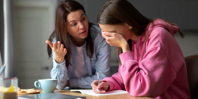 mom having serious conversation with upset daughter