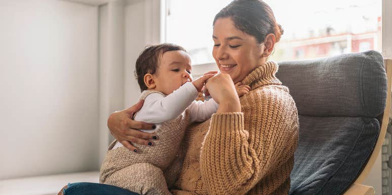 mom sitting in chair and holding baby