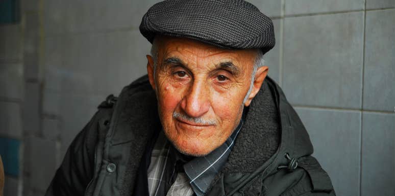 An elderly man in a flat cap looking serene and peaceful, illustrating the profound moment of acceptance when a terminal cancer diagnosis becomes a source of inner clarity.