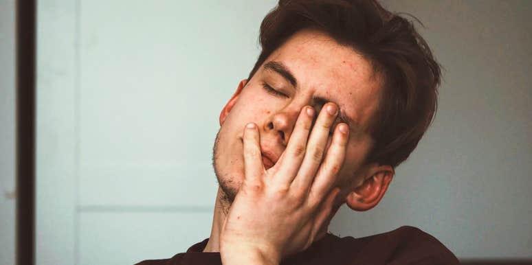 A stressed professional man looking overwhelmed; a visual representation of the harsh realities and legal nuances behind why even top-tier employees can be let go.