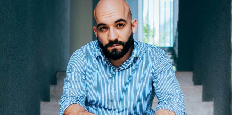 A man sitting alone on stairs, capturing the 'silent warning signs' and the psychological toll of a missed medical diagnosis before a major cardiac event.
