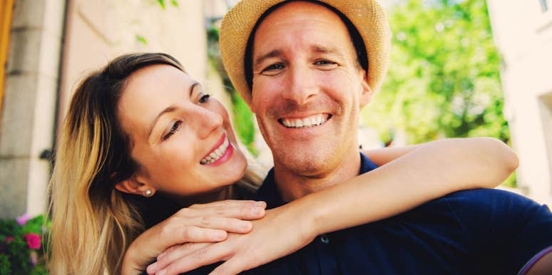 A couple sharing a joyful moment during an outdoor stroll; illustrating the core priorities—such as shared values and emotional intimacy—that sustain a healthy and thriving marriage.