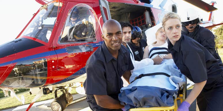 paramedics getting patient off a medevac flight on hospital's helipad