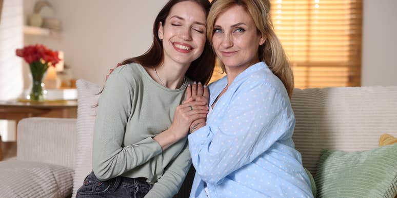 mom and adult daughter smiling