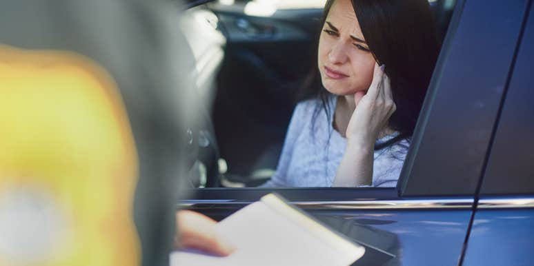 woman getting a ticket from a police officer