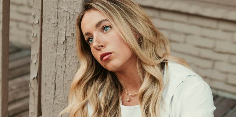 Woman who needs a break staring out into the distance looking numb 