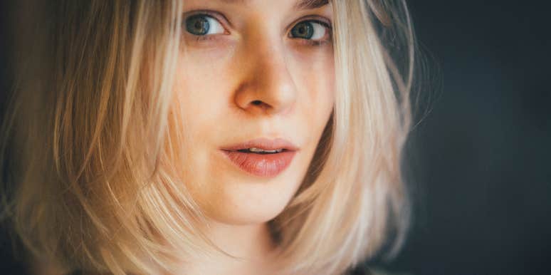 Woman who is doing better than most smiling slightly darkened room