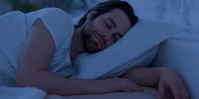 man sleeping peacefully in bed