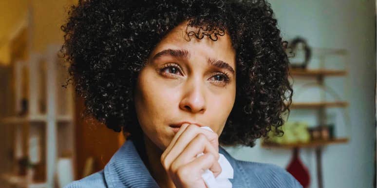 worried woman looking at a phone with an alarmed expression; illustrating the 'digital secrecy' and unexplained changes in routine that psychologists identify as the most common indicators of infidelity.