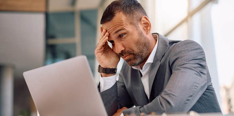 stressed intelligent businessman looking at laptop