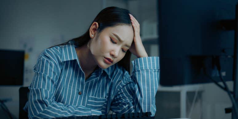 stressed employee sitting at desk in office