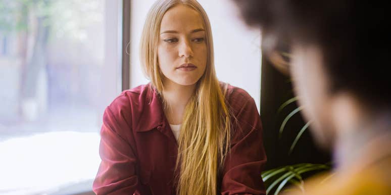 sad woman having a conversation with a friend in public