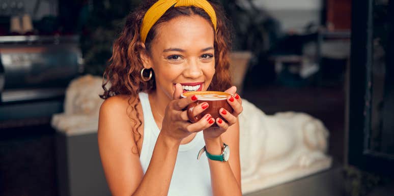 happy woman sitting in a cafe drinking coffee