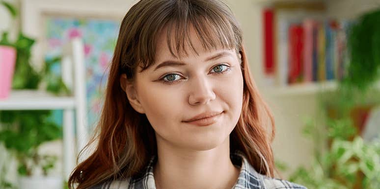Emotionally strong young woman smiles confidently 