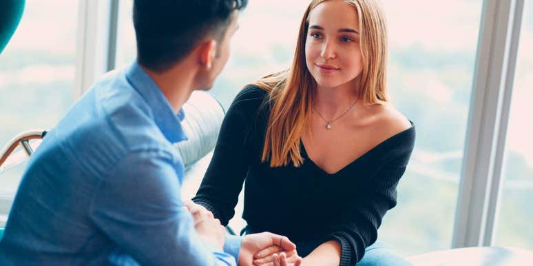 man holding hands with his truly intelligent wife at home