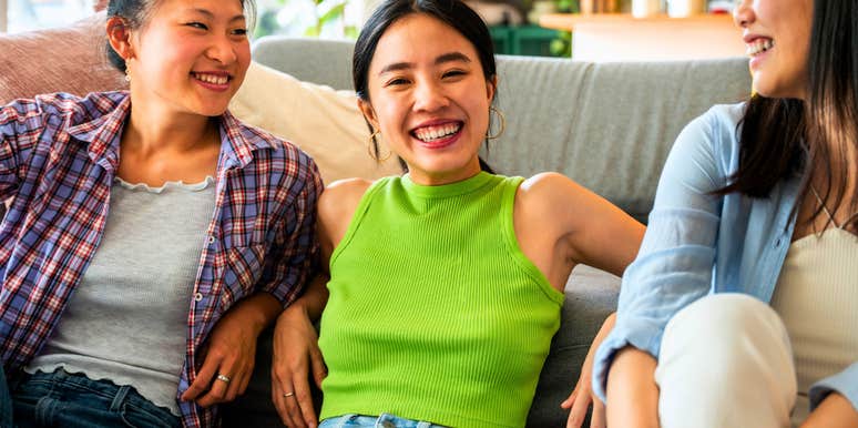 sarcastic and honest woman sitting with friends laughing