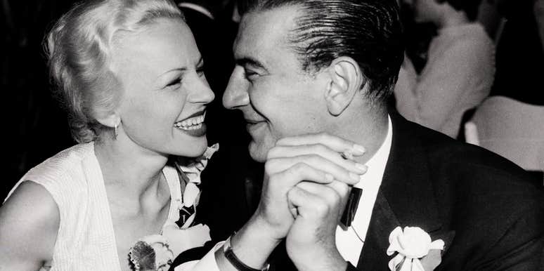 An archival closeup portrait of a cheerful mid-century teenage couple sharing a romantic moment; illustrating 'intentional courtship' and the offline communication skills returning to modern dating.