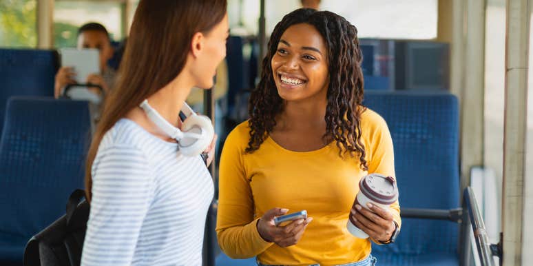 woman engaging in small talk with stranger on the bus