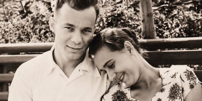 A textured 1950s era photograph of a group of attractive youth sitting closely together outdoors; illustrating 'structured connection' and the timeless dating ethics modeled by the older generation.