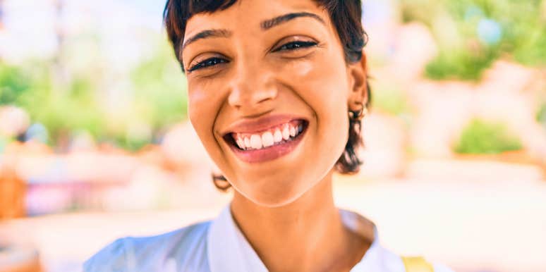 vibrant woman who is impossible to forget smiling outside