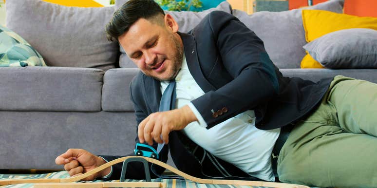 nostalgic intelligent man playing with toys that made him happy as a kid