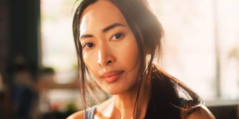 A candid close-up portrait captures a resilient woman. Symbolizing the mental and physical toll of fighting against institutional prejudices.