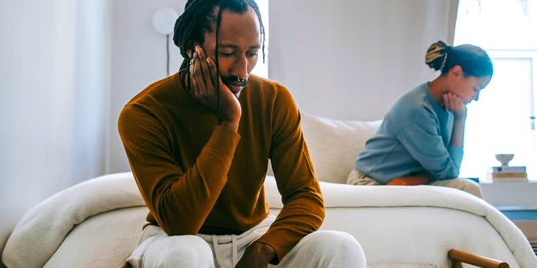 sad man turned away from wife emotionally checked out
