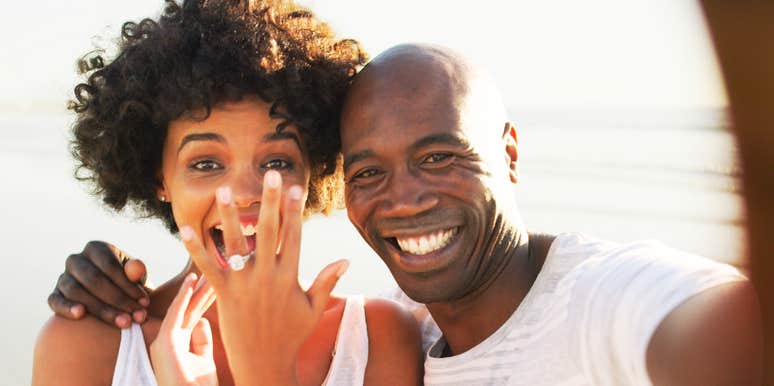 A stylish, confident couple sharing a warm, authentic moment during an engagement, illustrating emotional maturity, mutual ambition, and relational equality.
