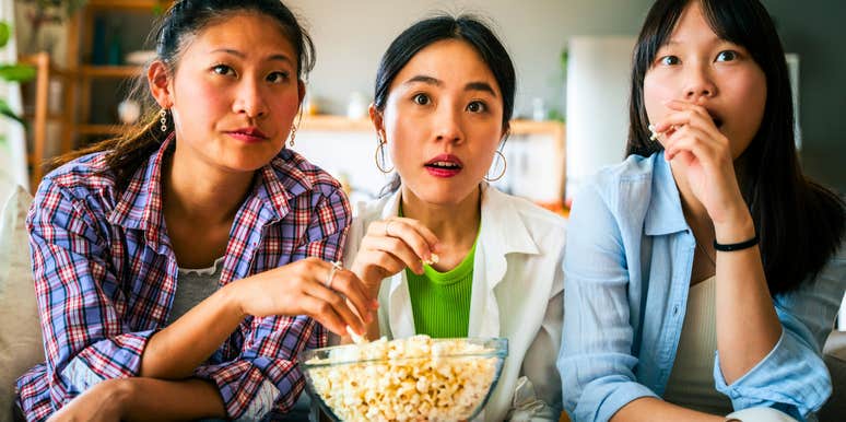 group of millennial women watching tv together